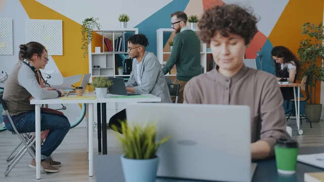Creative workspace with diverse team collaborating on projects in a modern office setting. Verksamhetslokaler: krav, avtal och kostnader för olika branscher